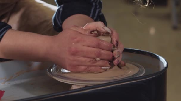 Pottery crafting - forming a wet clay in longer shape adding water in process — Stock Video