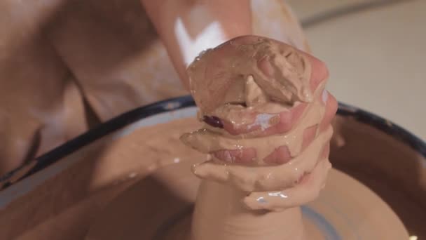 Pottery crafting - woman hands forming wet clay in longer shape and making it more plastic — Stock Video