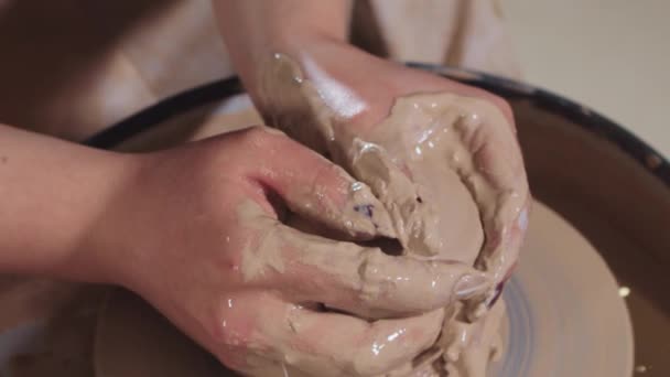 Pottery crafting - woman hands forming wet clay from longer shape to shorter and more plump making it more plastic — Stock Video