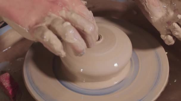 Pottery crafting - makes a recess in the wet clay with a finger — Stock Video