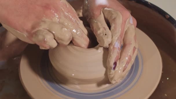 Pottery crafting - making a pot out of wet clay on the potters wheel — Stock Video