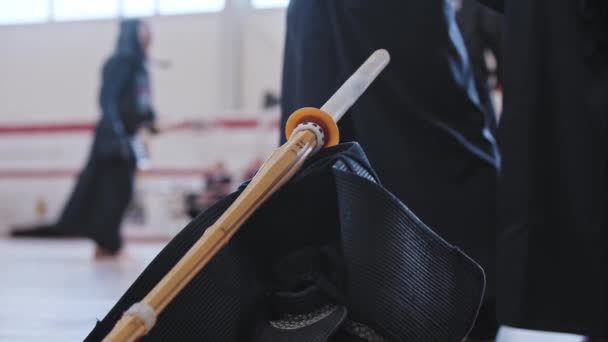 Torneo de Kendo: ropa negra y palo de bambú en el suelo — Vídeo de stock