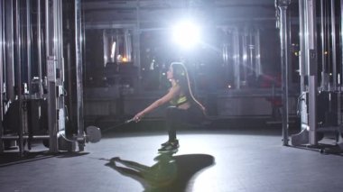 Young woman pumping her butt in the gym