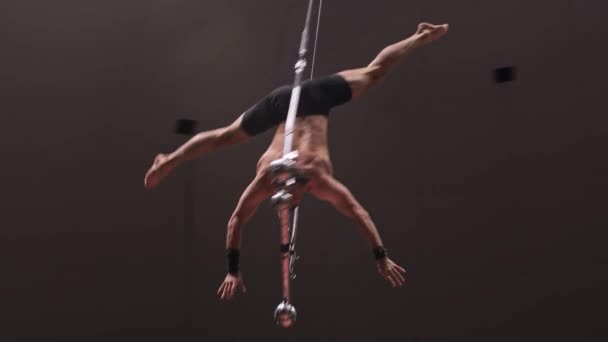 Acrobatic shirtless man giving out a performance upside down at the circus arena — Stock Video