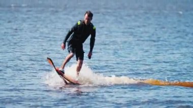 KAZAN, RUSSIA 21-05-21: professional man riding on the water on the flyboard