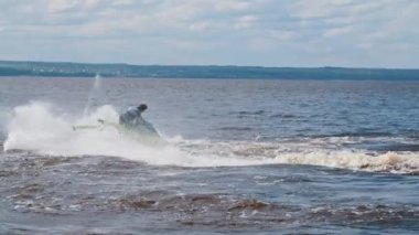 KAZAN, RUSSIA 21-05-21: a man riding yellow jet ski on the water