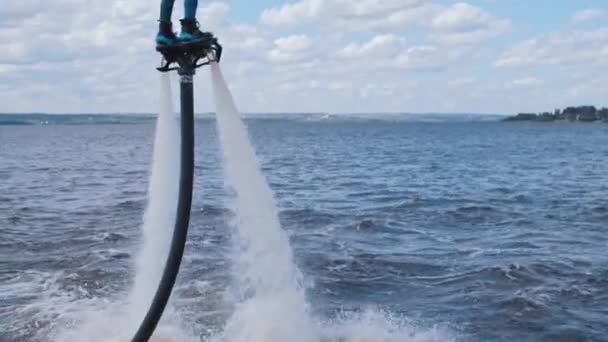 Sportieve man die boven het water vliegt en een salto maakt — Stockvideo