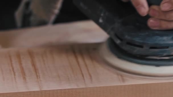 Carpentry - worker grinding tne flat surface of a wooden detail — Stock Video