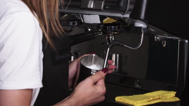 Barista hembra espumas de leche para capuchino usando máquina de café — Vídeos de Stock
