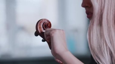 Genç sarışın kadın müzisyen çalmadan önce keman çalıyor.