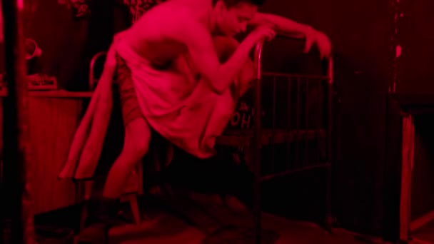 Mentally unstable half naked man going crazy in hospital room with red lighting — Stock Video