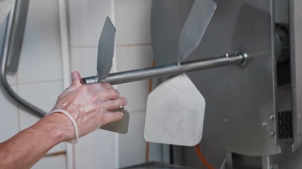 Cheese making insustry - man worker putting a large valve in a vat of liquid cheese base — Stock Video