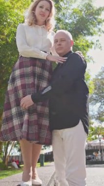 Mutlu olgun turistler, güzel şehir bahçesinde sevgi gösteriyorlar.