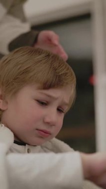 Anne banyodan sonra oğlunun saçını tarıyor.