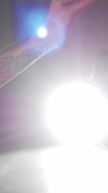 A woman training brown german shorthaired dog and giving it a treat. Mid shot