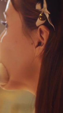 A cute girl cosplayer powdering her face using a brush. Mid shot