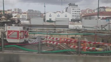 3 Şubat 2026, Lizbon, Portekiz - Bir şehirde ağır ekipmanlı büyük bir inşaat alanını gösteren bir pencereden çekim