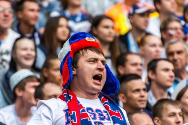Kazan, Russia - June 24, 2017.  Russian fan wearing an ear-flapped hat at FIFA Confederations Cup 2017 match Mexico vs Russia. clipart