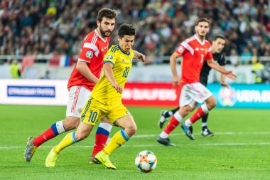 Kalininingrad, Rusya - 9 Eylül 2019. Kazakistan milli futbol takımı orta saha oyuncusu Georgi Zhukov UEFA Euro 2020 ön eleme karşılaşmasında Rusya ile Kazakistan (1-0) karşılaşmasında Rusya defans oyuncusu Georgi Dzhikiya 'ya karşı Kalininingrad' da oynanan karşılaşma..