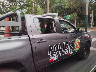 Lima, Peru - 24 Mayıs 2025: Kamu parkı Bosque El Olivar yakınlarındaki San Isidro bölgesinde devriye gezen polis Nacional del Peru 'nun polis aracı olarak işaretlenmiş kargo yataklı Toyota Hilux. Kapıda renkli rozet var..