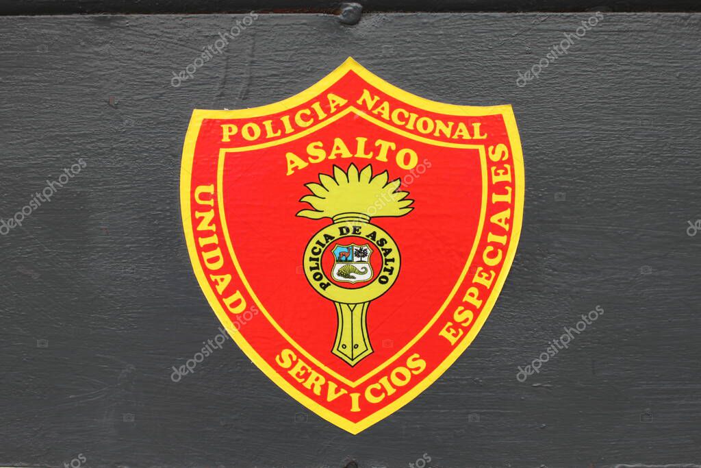 Lima, Peru - May 24, 2025: Close up of coat of arms of National Police Assault Unit, Special Services Unit (Policia Nacional de Asalto, Unidad Servicios Especiales). Dark painted metal background.