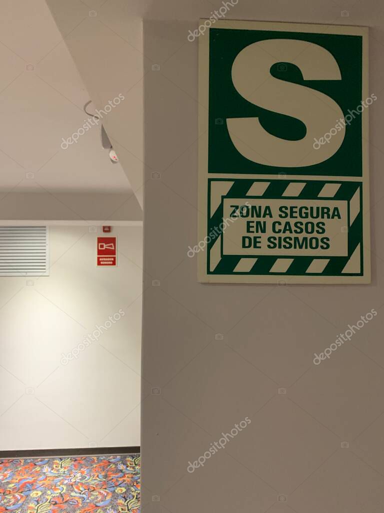 Lima, Peru - May 24, 2025: Precautionary measures in public building: Signs indicating zona segura en casos de sismo (Safe area in case of earthquake) and avisador sonoro (sound warning).