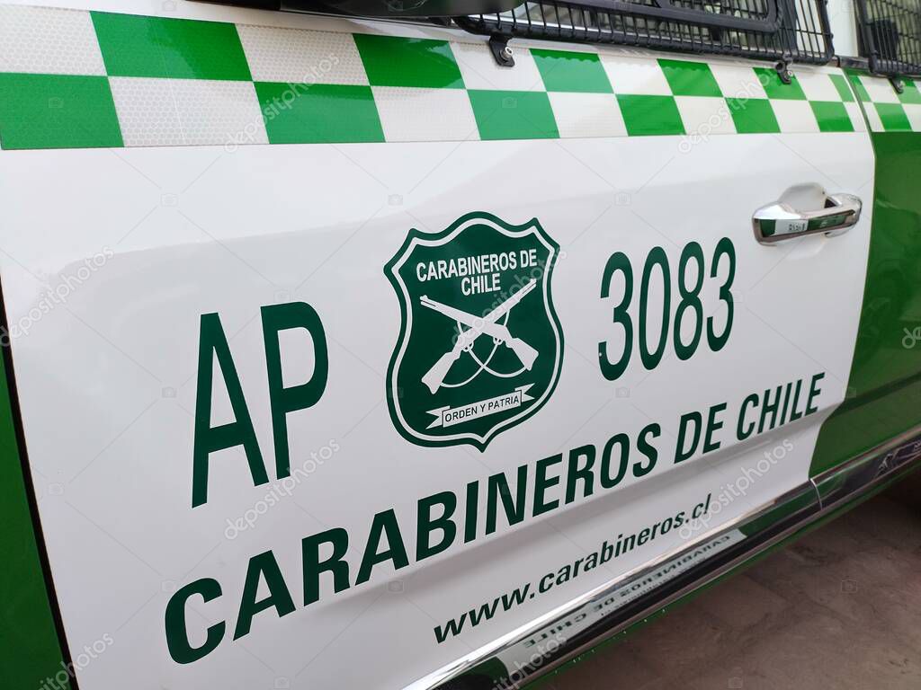 San Pedro de Atacama, El Loa, Antofagasta, Chile - June 04, 2025: Green white police patrol car of Carabineros de Chile parked at local police station. Metal mesh protects windows from thrown stones.