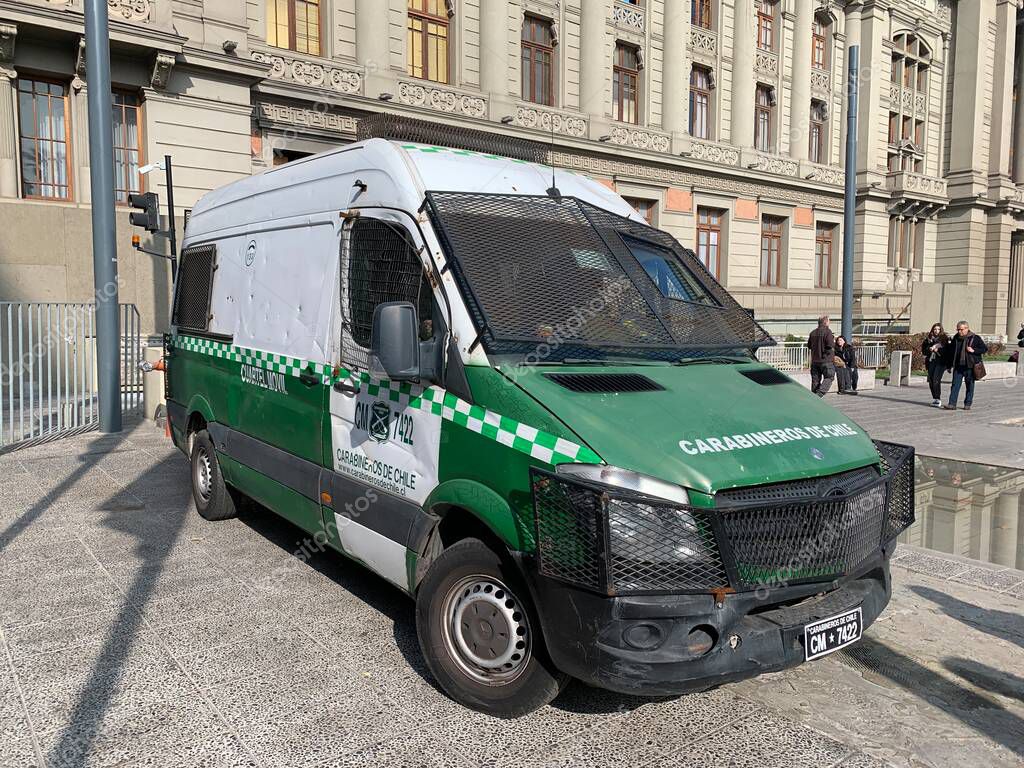 Santiago, Chile - June 07, 2025: Parked green white Mercedes cuartel movil vehicle of Carabineros de Chile. Dented and rusted. Metal mesh protects windows from thrown stones.