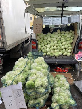 Miercurea Ciuc, Csikszereda, Szeklerburg, Harghita, Romanya - 24 Ekim 2025: Doğu Avrupa 'da tipik pazar sahnesi. Doğrudan minibüsten satılan taze sebzeler. Lahana dolu kuyruk kapısı açık bir kamyon. Romen ve Macarca işaretler.