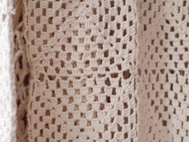 Örülmüş doku arka planı, bej örgü kumaş, boşluklu bej arkaplan