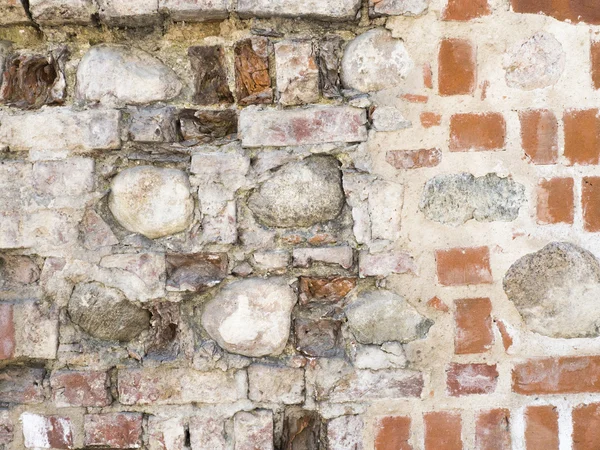 Textura de la antigua pared de ladrillo rojo dañado con fondo de piedra — Foto de Stock