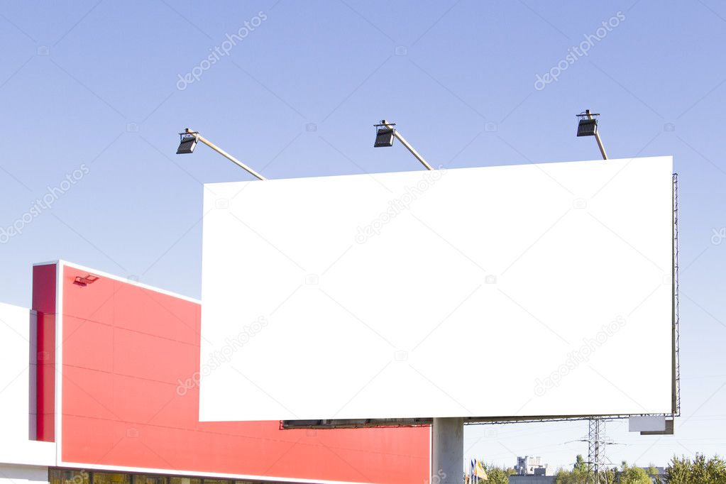 Blank billboard in the city against blue sky