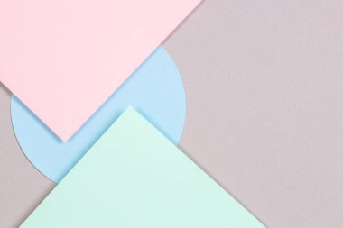 Moda arka planının soyut geometrik yapısı yumuşak yeşil, pastel pembe, açık mavi, gri renkli kağıt. Üst manzara, düz uzanma
