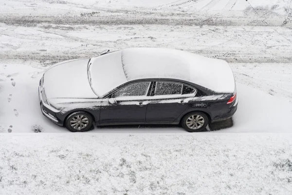 One car covered with thick layer of snow parked in yard in winter time. Aerial view