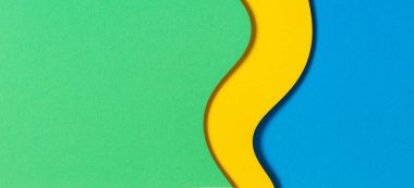 Soyut renk kağıtları geometri düz kompozisyon pankart arka planı mavi, sarı ve yeşil renk tonlarıyla