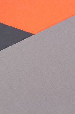 Creative abstract geometric colored paper background in orange, gray, black colors