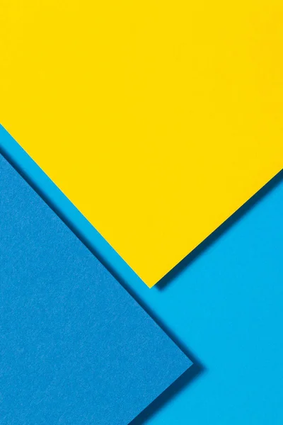 Abstract color papers geometry flat lay composition background with yellow and blue tones — Stock Photo, Image
