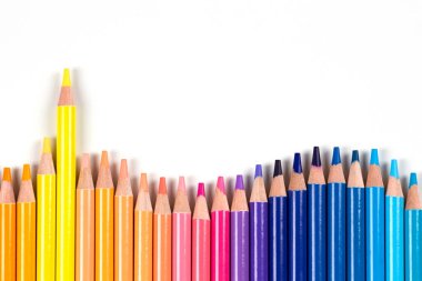 Colored pencils frame on white background. Top view. Learning, art, diversity, creative entertainment concept