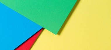 Soyut renk kağıtları geometri düz kompozisyon pankart arka planı mavi, sarı, kırmızı ve yeşil renk tonlarıyla