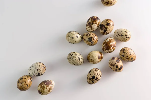 Raw quail eggs on white background