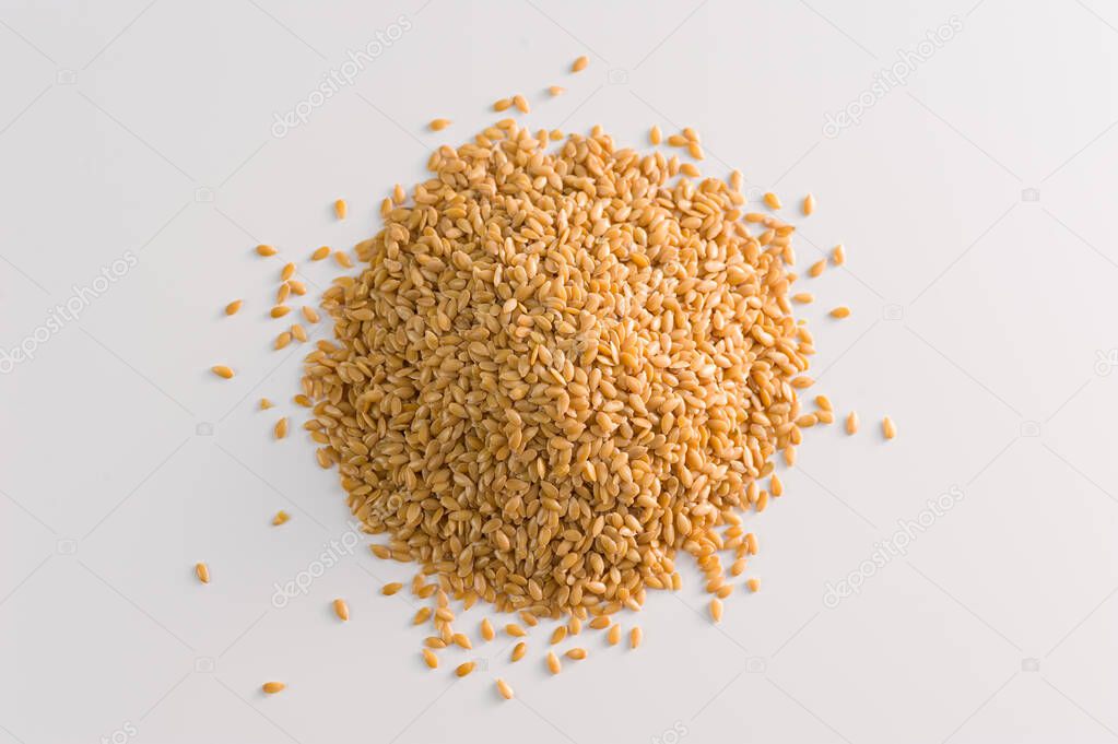 Flax golden, seeds on a white background close up