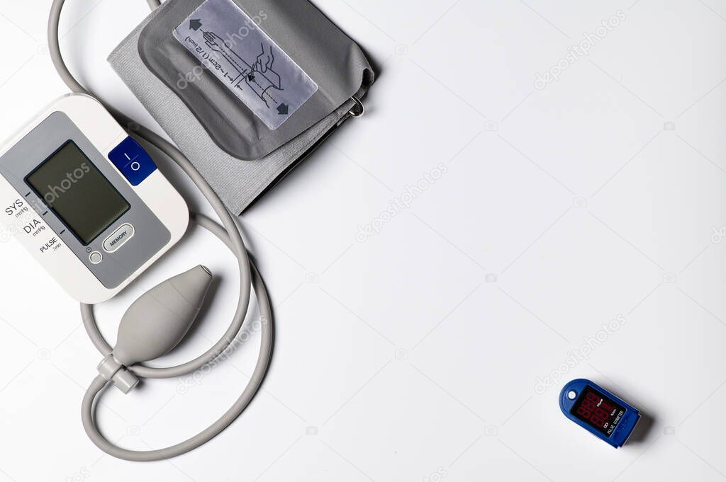 tonometer and pulse oximeter on white background