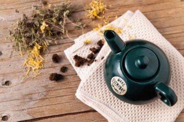 Homemade Herbal Soothing Immune Booster Tea, Chamomile & Calendula in Green Ceramic Teapot clipart