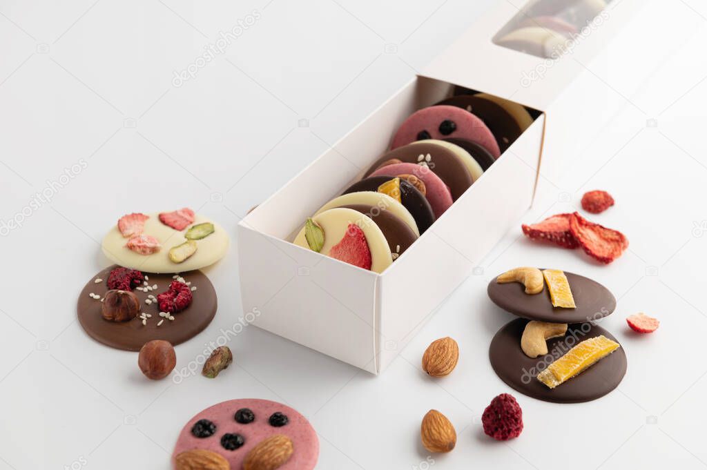 a set of handmade chocolate with dried fruits, nuts, mediants, congratulatory packaging