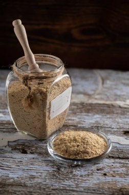 Taneli besin maya, devre dışı bırakılmış, canlı değil, B vitamini, bir kavanozda ahşap arka planda, yakın plan, yan görüş