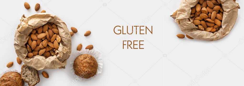 banner, almond flour gluten-free muffins, almonds in craft paper, keto food, on white background, top view, blank space for text