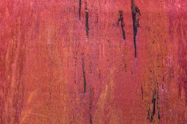 Raue Metallwand mit Teerspuren überwiegend rot mit Kratzern — Stockfoto