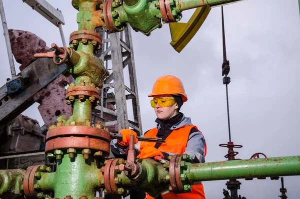 Kvinnan ingenjör i fältet olja reparera wellhead — Stockfoto