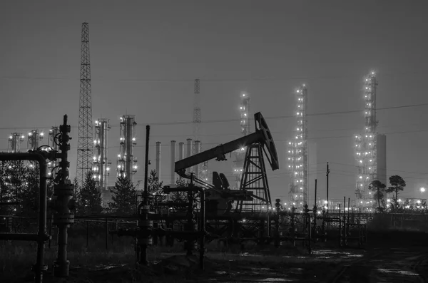 Grupo de plataformas petrolíferas y cabeza de pozo en el fondo de la refinería . — Foto de Stock