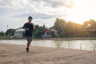 Bulutlu gökyüzü ile koşan bir adam